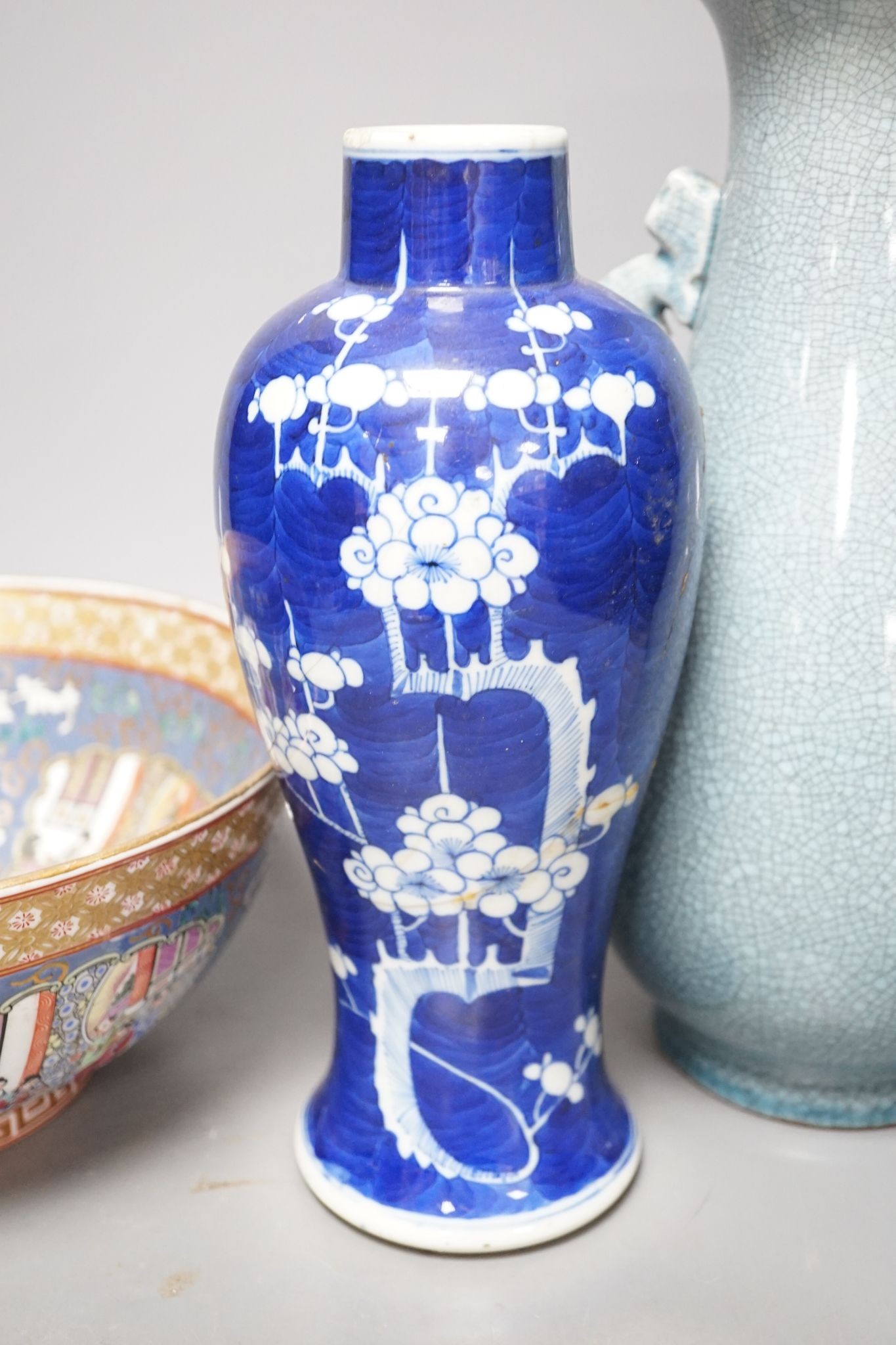 A Chinese blue and white Prunus vase, a Chinese enamelled porcelain bowl and a pale blue crackle glaze vase, tallest 32 cm